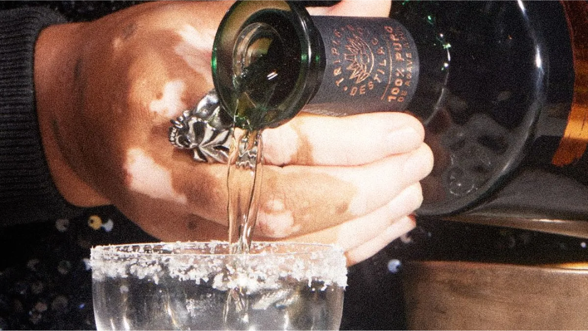 Pouring glass of tequila with salt rim Tres Generaciones