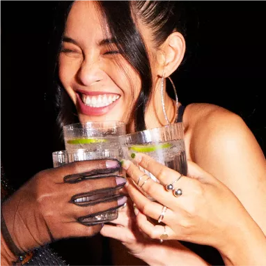 Girl smiling with tequila drinks