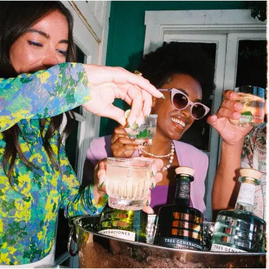 Girls smiling with tequila drinks